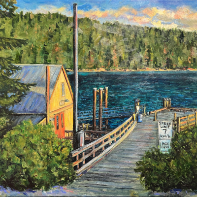 The Shed at Port Washington on Pender Island is of a scene looking down the hill towards the dock with the building on the left bathed in sunset light