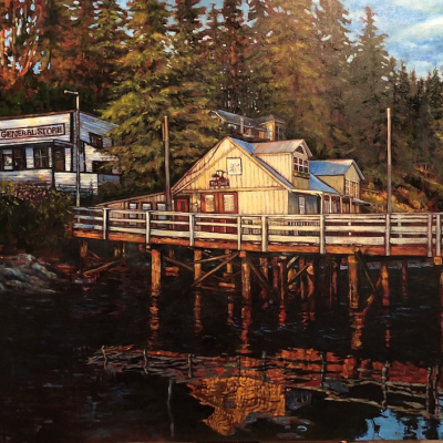 Port Washington, Pender Island, BC is of the old historical buildings as seen from the water with reflections at sunset